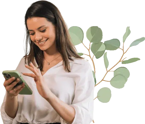 A woman looking at her phone smiling.