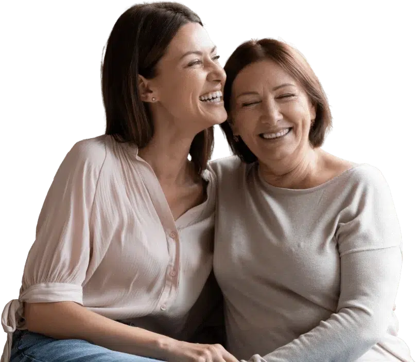Two happy women gently embracing one another.