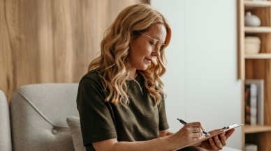 Psychologist reading a client's Mental Health Treatment Plan ahead of their appointment.