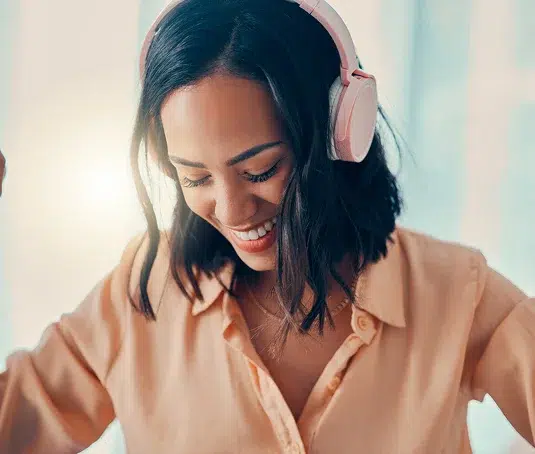 Very happy lady, listening to something through headphones.