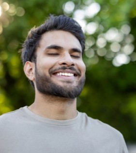 A smiling, contended man who feels confident and secure in himself.
